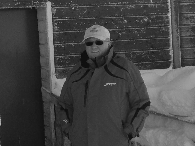 Czarno-białe zdjęcie Stanisława Ślęzaka w zimowej sportowej kurtce